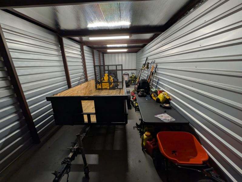 Utility trailer, commercial mower, and organized tool setup