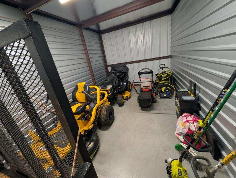 Full equipment lineup with mowers, trailer, pressure washer, and trimmers