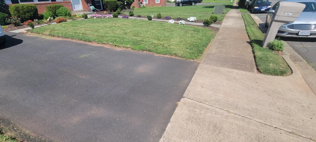 Front yard lawn with crisp edging along driveway and sidewalk