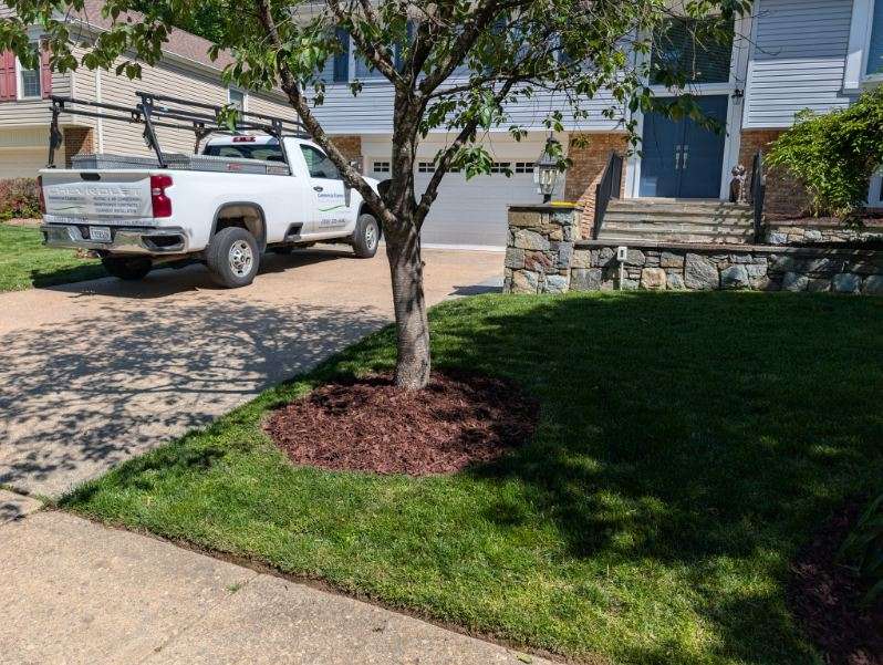 Dark mulch installation at a modern home entrance