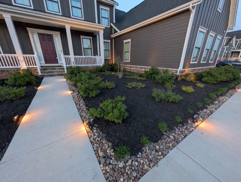 Mulched foundation bed with pink flowering shrubs
