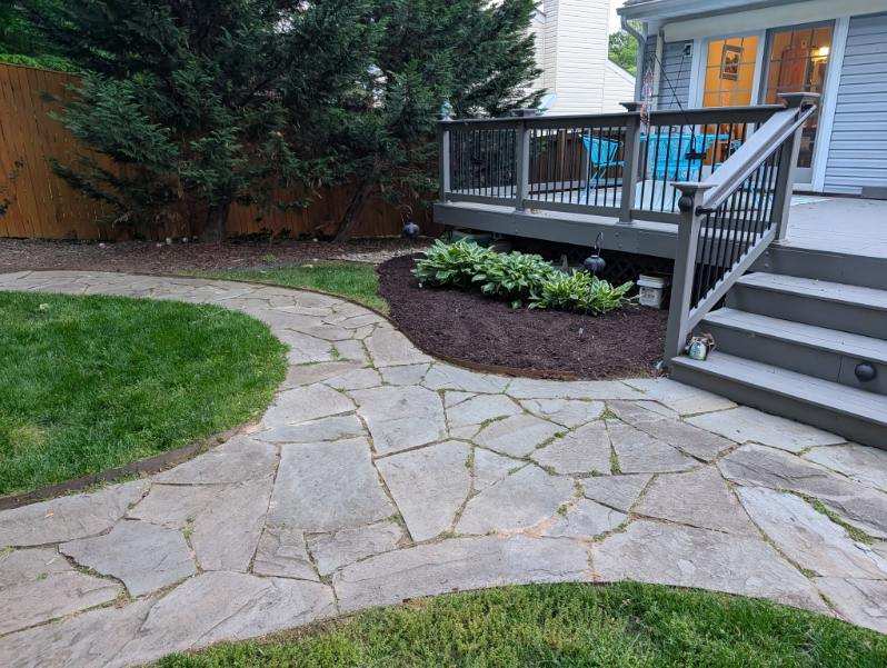 Hosta bed with dark mulch and deck edging