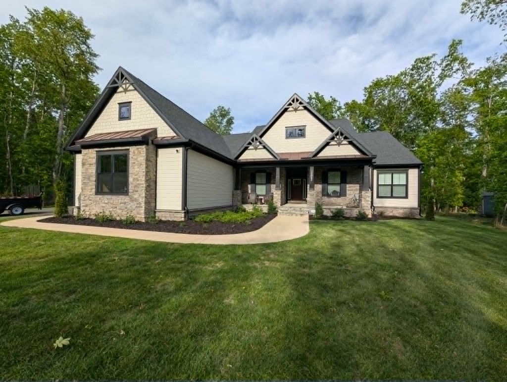Foundation mulch beds with shrubs along a modern craftsman home