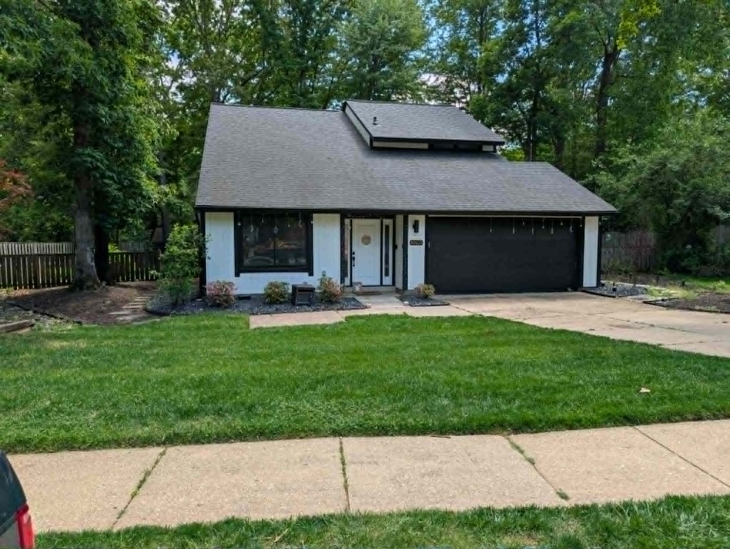 Modern home entrance with fresh mulch beds and manicured lawn